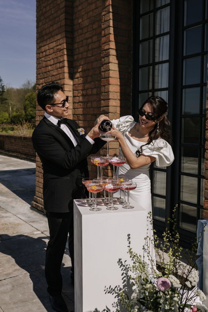 brautpaar gießt den den champagnertower ein, auf der dachterasse beim Kosaido in düsseldorf